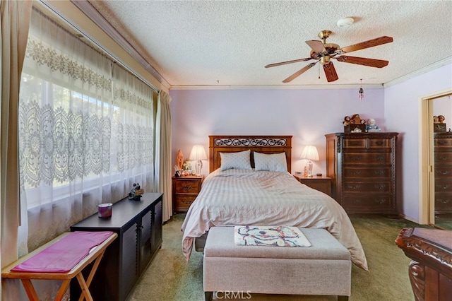 carpeted bedroom with multiple windows, ceiling fan, crown molding, and a textured ceiling