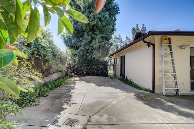 view of side of home featuring a patio area