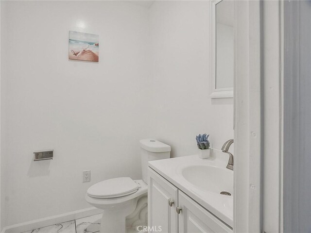 bathroom with toilet and vanity