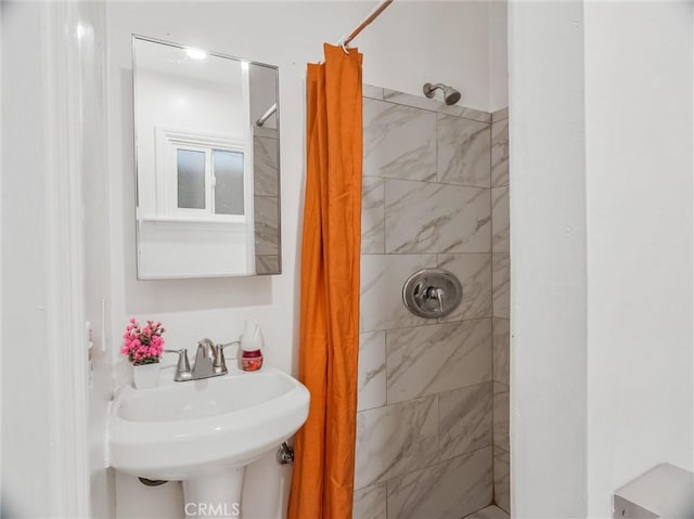 bathroom featuring walk in shower and sink