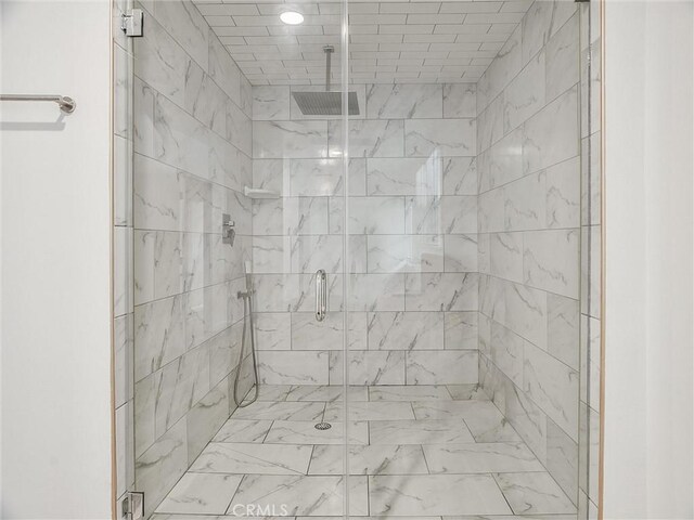 bathroom featuring a shower with shower door