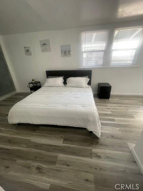 bedroom with wood-type flooring