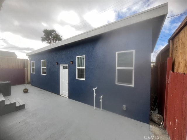 back of property featuring a patio area and cooling unit