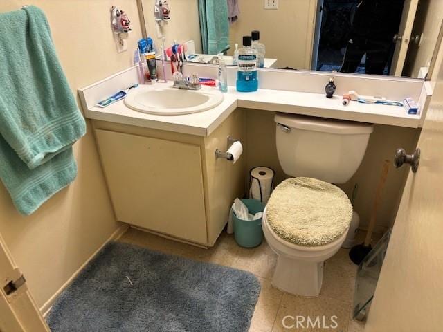 bathroom with vanity, tile patterned floors, and toilet