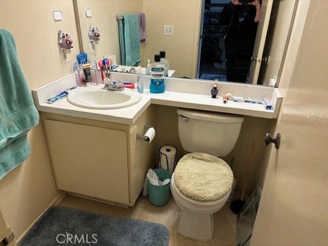 bathroom with tile patterned floors, vanity, and toilet