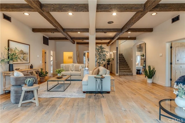 living room with beam ceiling, light hardwood / wood-style flooring, and coffered ceiling