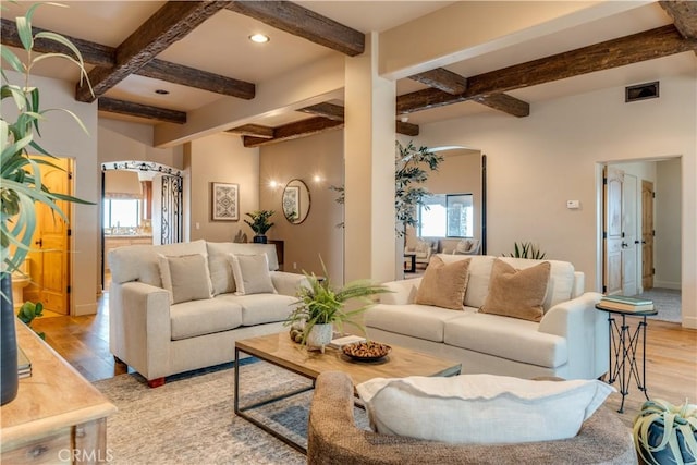 living room with light hardwood / wood-style flooring, beamed ceiling, and coffered ceiling