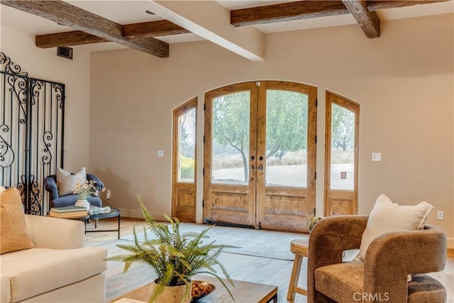entrance foyer featuring beamed ceiling, french doors, and hardwood / wood-style floors