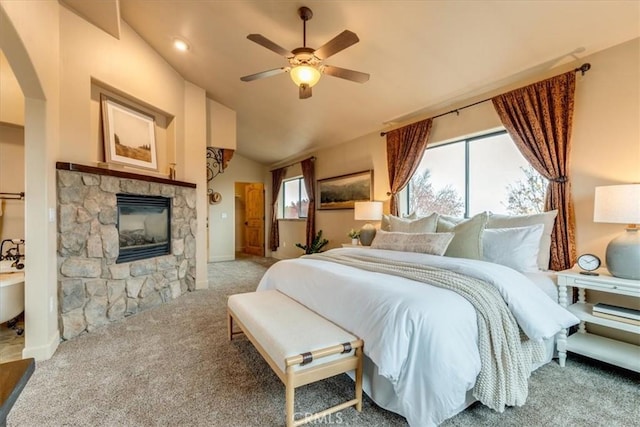 bedroom featuring carpet, ceiling fan, lofted ceiling, and a fireplace