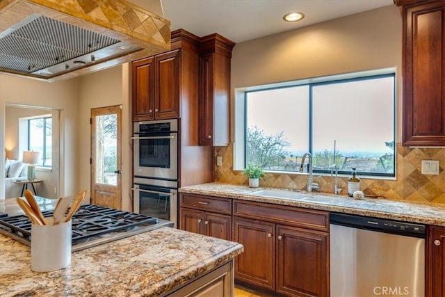 kitchen with a wealth of natural light, sink, extractor fan, and appliances with stainless steel finishes