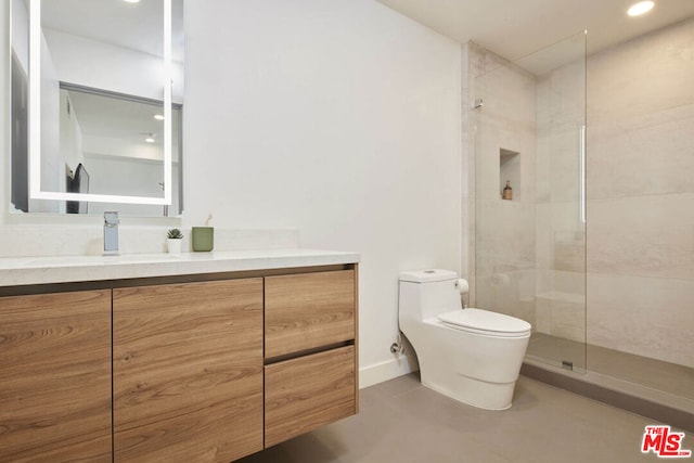 bathroom with vanity, a shower with shower door, and toilet