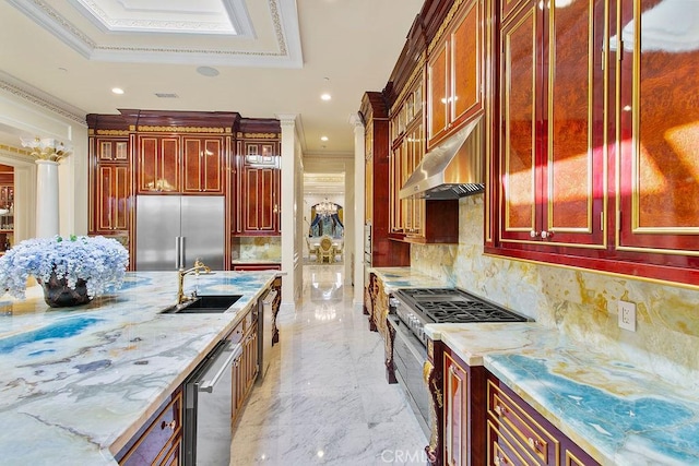 kitchen with high end appliances, marble finish floor, dark brown cabinets, under cabinet range hood, and a sink