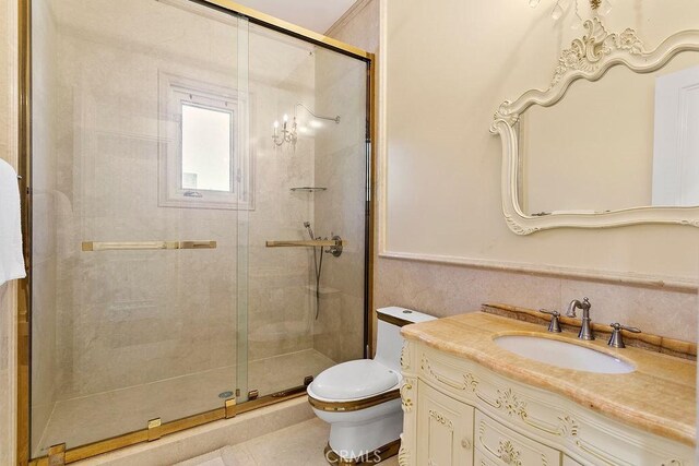 bathroom with vanity, a shower with shower door, and toilet