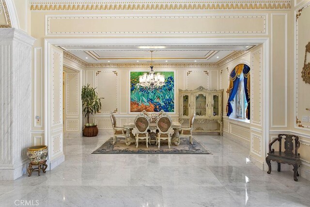 dining space with crown molding and a chandelier