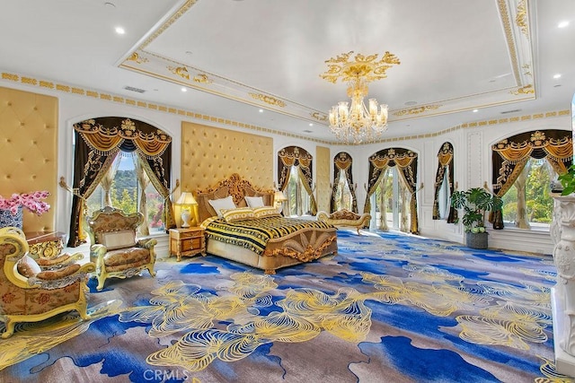 bedroom with multiple windows and a tray ceiling