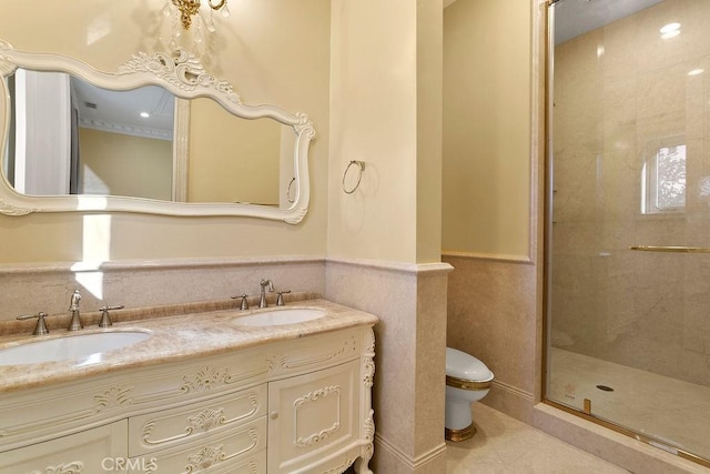 bathroom featuring vanity, toilet, and a shower with door