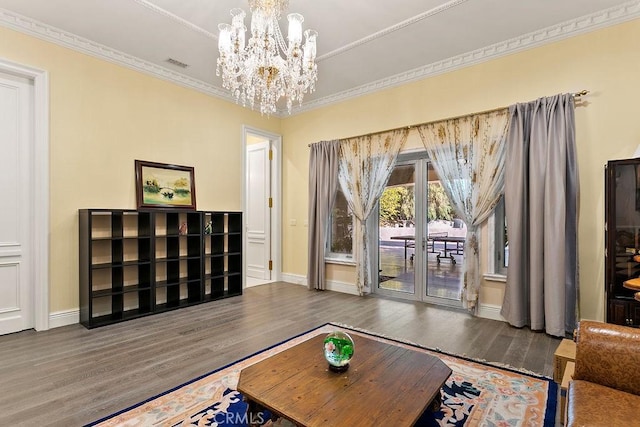 living room featuring dark hardwood / wood-style flooring, a notable chandelier, crown molding, and french doors