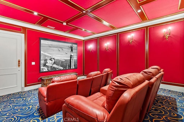 carpeted home theater with coffered ceiling and crown molding