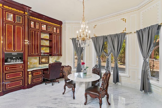 dining space featuring a decorative wall, marble finish floor, ornamental molding, built in study area, and an inviting chandelier