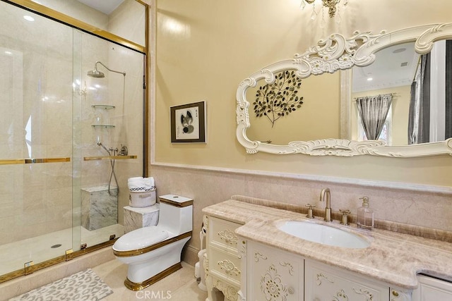 full bathroom with a wainscoted wall, a shower stall, toilet, and vanity