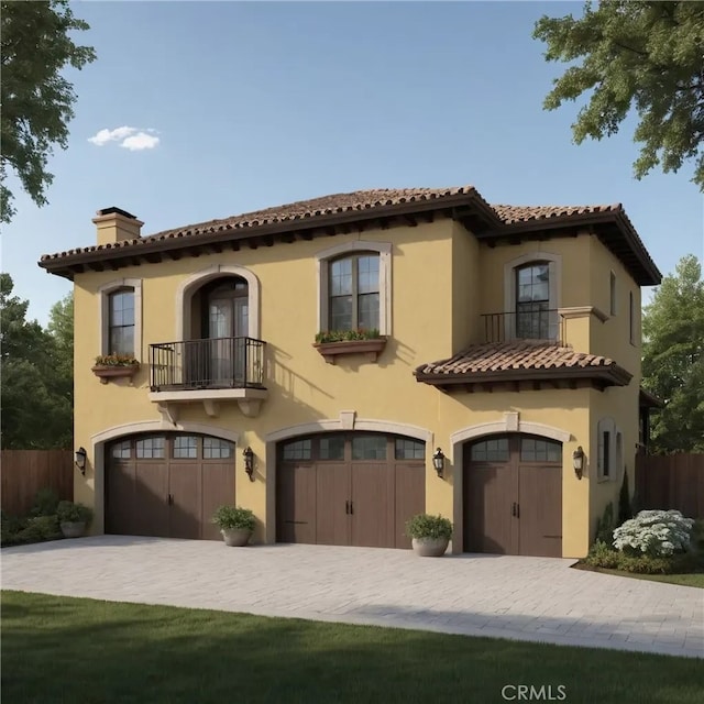 mediterranean / spanish house with a garage and a balcony