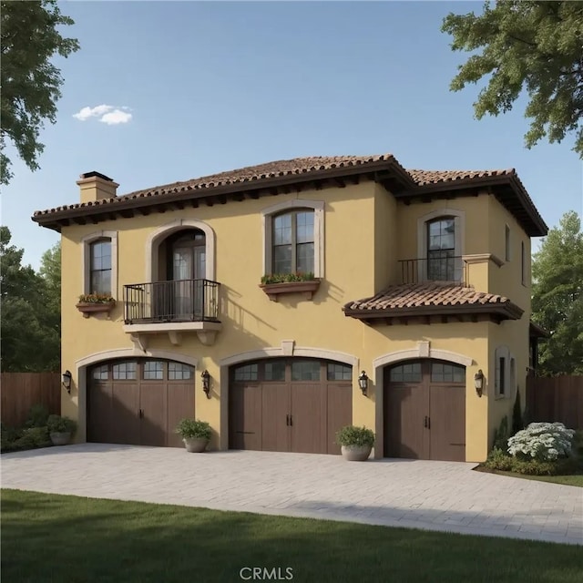 mediterranean / spanish house with a chimney, stucco siding, fence, a balcony, and a garage