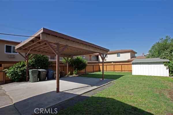 view of yard with a carport and a storage shed