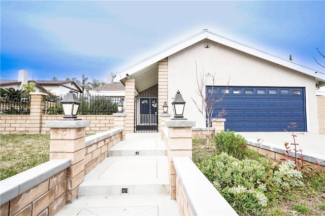 2425 N Fillmore Ave, Rialto, CA 92377 - view of front of home with stucco siding, fence, and a garage