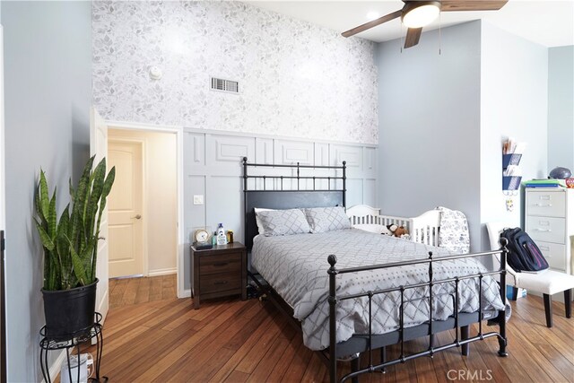 2425 N Fillmore Ave, Rialto, CA 92377 - bedroom featuring a ceiling fan, wood-type flooring, visible vents, and wallpapered walls