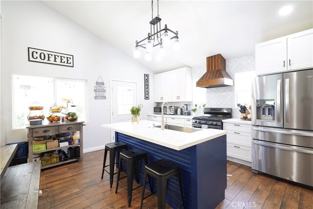 2425 N Fillmore Ave, Rialto, CA 92377 - kitchen featuring a sink, dark wood-type flooring, backsplash, custom range hood, and appliances with stainless steel finishes
