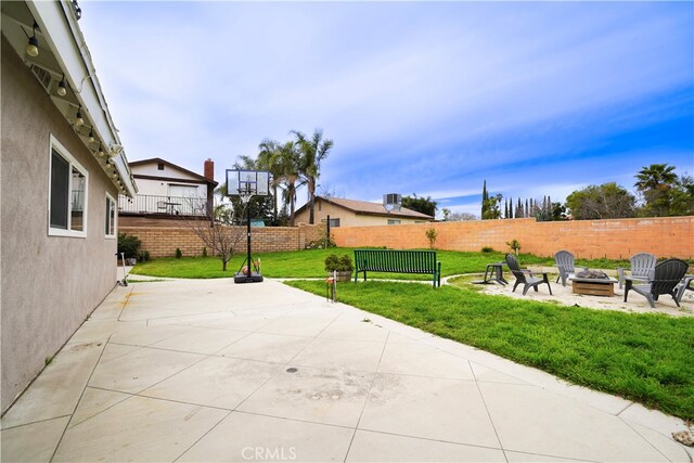 2425 N Fillmore Ave, Rialto, CA 92377 - view of patio with an outdoor fire pit and a fenced backyard