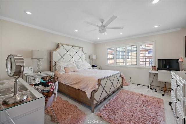 carpeted bedroom featuring ceiling fan and ornamental molding