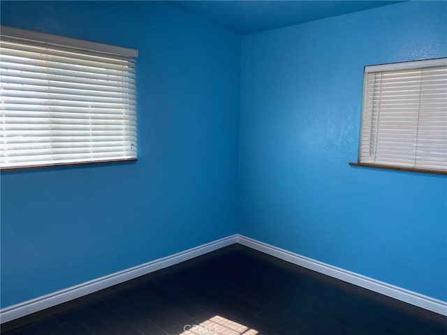 unfurnished room with hardwood / wood-style flooring