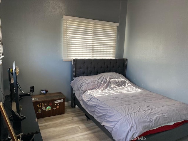 bedroom with light hardwood / wood-style floors