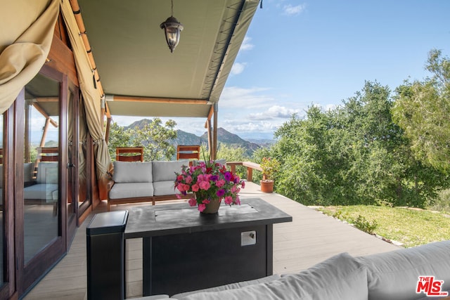 view of patio with a deck with mountain view and an outdoor hangout area