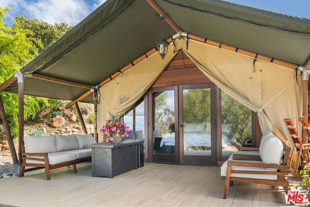 wooden terrace featuring a gazebo and outdoor lounge area