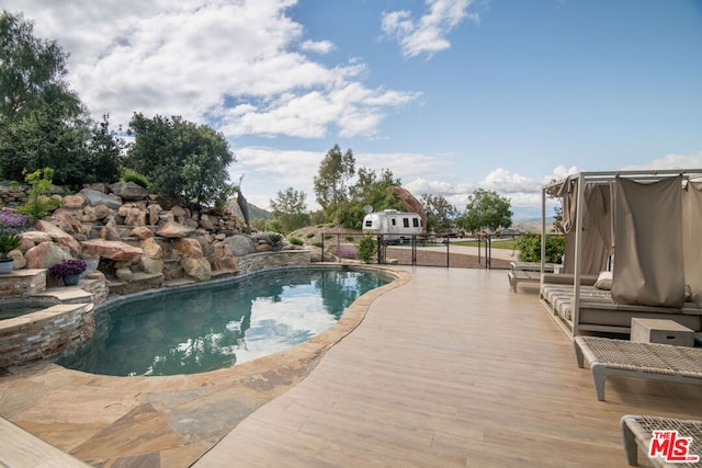 view of swimming pool with a deck