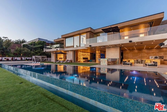 pool at dusk featuring a patio