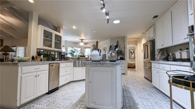 kitchen featuring high end fridge, sink, white cabinetry, kitchen peninsula, and ceiling fan