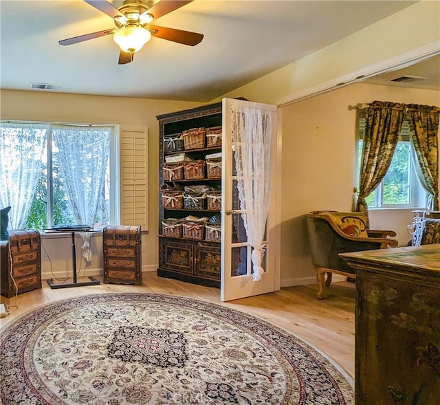 sitting room with hardwood / wood-style flooring and ceiling fan