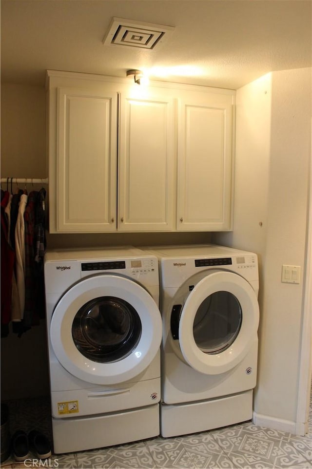 laundry room with cabinets, independent washer and dryer, and light tile patterned floors