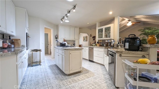 kitchen featuring white cabinetry, a center island, lofted ceiling with beams, kitchen peninsula, and stainless steel appliances