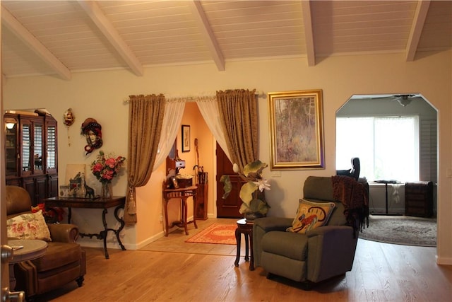 sitting room featuring beamed ceiling and wood-type flooring