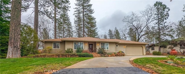 ranch-style house with a garage and a front lawn