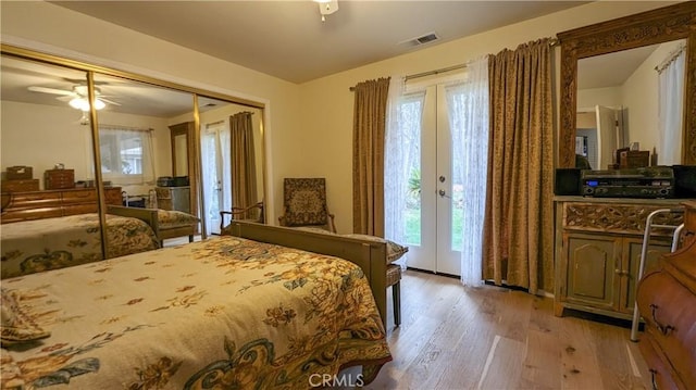 bedroom with light hardwood / wood-style flooring, ceiling fan, french doors, access to outside, and a closet