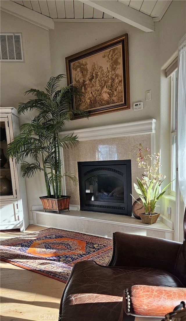 sitting room featuring wooden ceiling and vaulted ceiling with beams