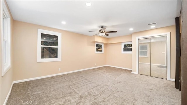 empty room with ceiling fan and carpet