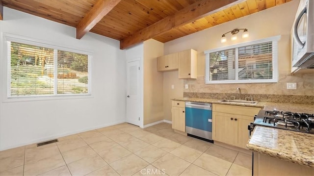 kitchen featuring beam ceiling, light stone countertops, dishwasher, light brown cabinets, and sink