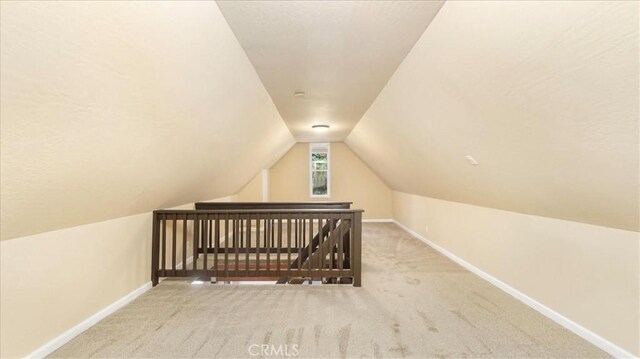 bonus room with carpet and vaulted ceiling