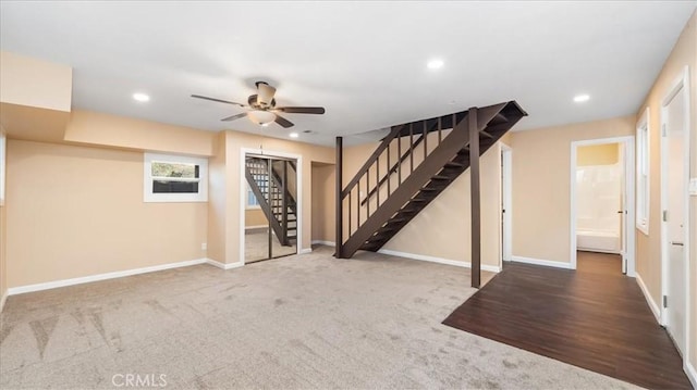 basement featuring ceiling fan and carpet floors